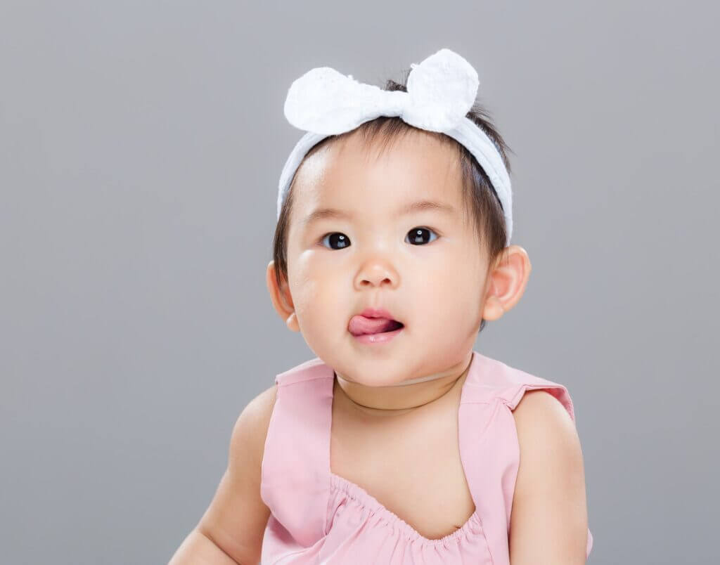 Asian baby girl show tongue
