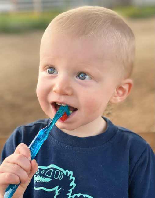 toddler brushing his small teeth