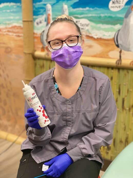 one of our friendly dental hygienist posing with fluoride foam