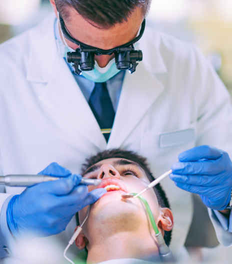 teenager getting his mouth inspected before a wisdom tooth extraction